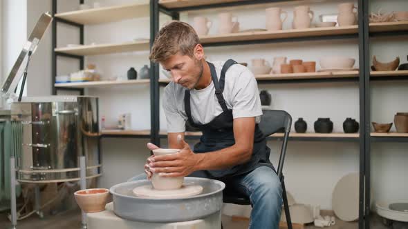 Man Potter Makes a Pitcher Out of Clay Handicraft Production of Handmade Tableware Pottery Workshop