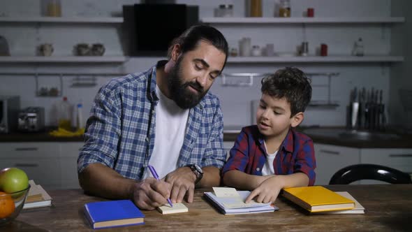 Positive Father Giving Housework Tasks To His Son