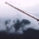 Construction site tower crane and flowing clouds over mountains background timelapse - VideoHive Item for Sale
