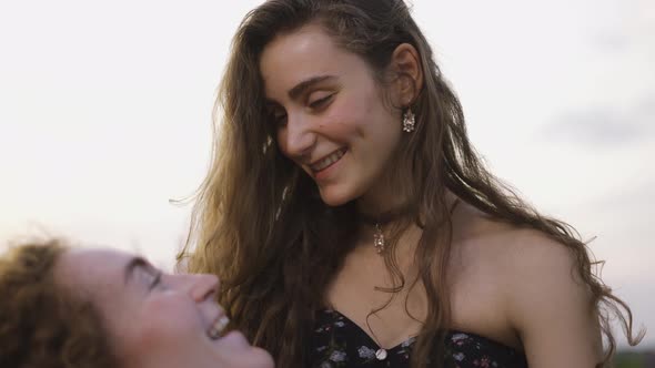 Curly Women Lovers Among a Lavender Field Embracing Enjoying Time Together