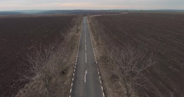 Drone Ascends Over Empty Asphalt Road In The Middle Of Nowhere. Aerial Shot