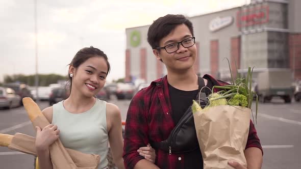 Smiling Happy Vietnamese People Standing with Food Bags