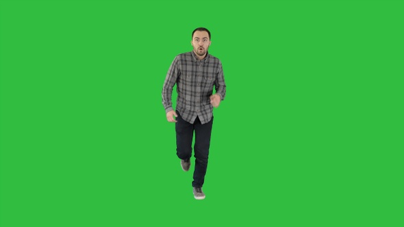 Man starting to run in casual clothes on a Green Screen