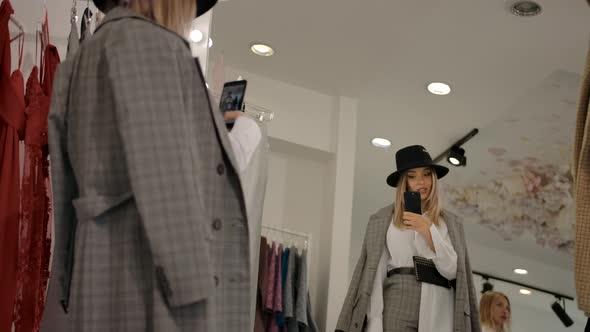 Trendy Lady Taking Selfie Near Shop Mirror