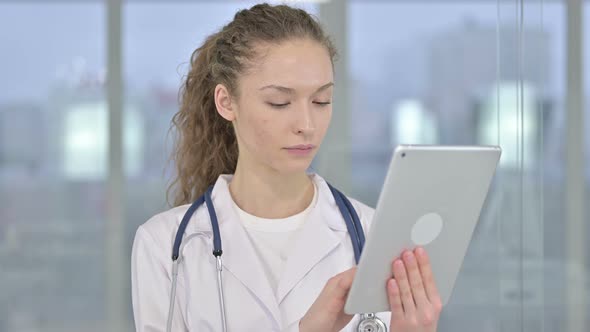 Portrait of Serious Young Female Doctor Using Tablet