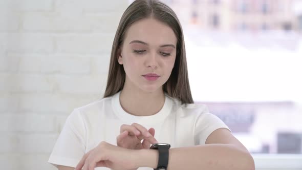 Portrait of Beautiful Young Woman Using Smartwatch 