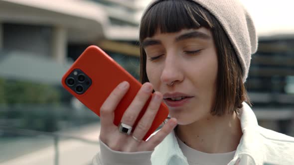 Female Shopper Using Mobile for Recording Audio Message
