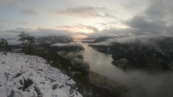 Wide Time Lapse clouds moving fast and rolling fog Norway Snowy Mountains