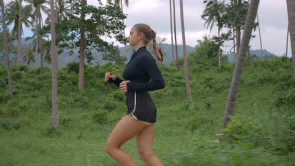 Pretty Well Built Female in Black Jogging Along Tropical Rain Forest Having Pleasant Time Outdoor