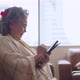 asian grandmother sit casual relax hand use smartphone technology device video call - VideoHive Item for Sale