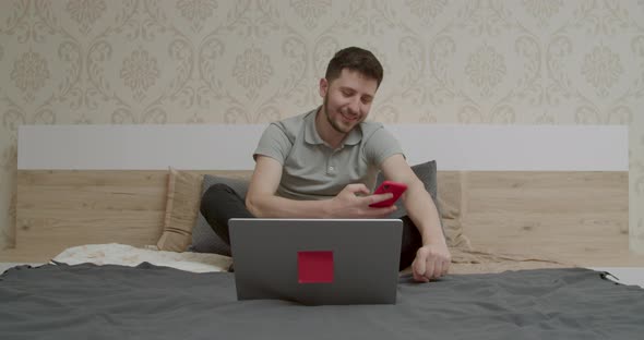 the Boy Looks at the Computer and is Happy