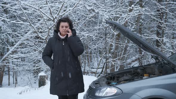 Sad Woman Standing Near the Broken Car and Calling