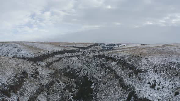 Rising drone shot of snowy canyon in Idaho