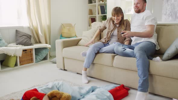 Parents Watching TV while Children Sleeping alt