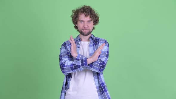 Serious Young Bearded Hipster Man Showing Stop Gesture