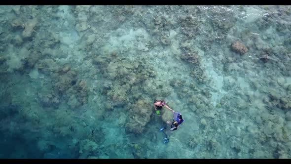 Teenage lovers in love on exotic shore beach journey by blue sea and white sand background of the Ma