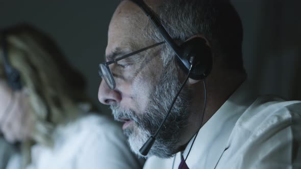 Close-up View of Mature Teleworker in Headset