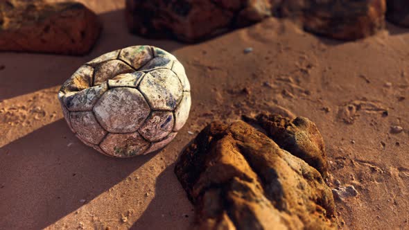 Old Leather Soccer Ball Abandoned on Sand