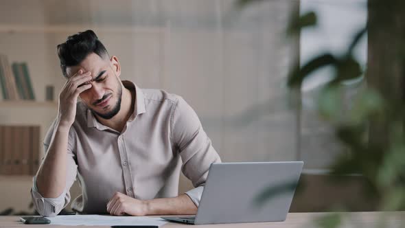 Unhappy Shocked Arabian Male Worker Look at Laptop Screen Feeling Nervous Upset with Bad News