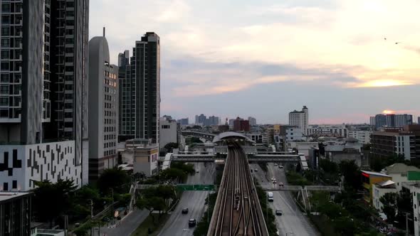 Hyperlapse along train track towards station with traffic passing by