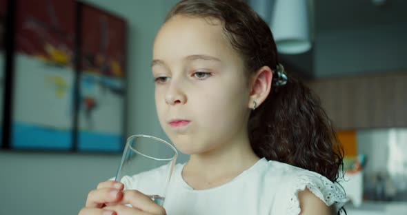 Cute Child Girl Drinking Glass Fresh Transparent Pure Filtered Mineral Water at Home