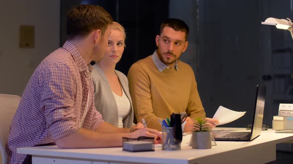 Business Team with Laptop Working at Night Office