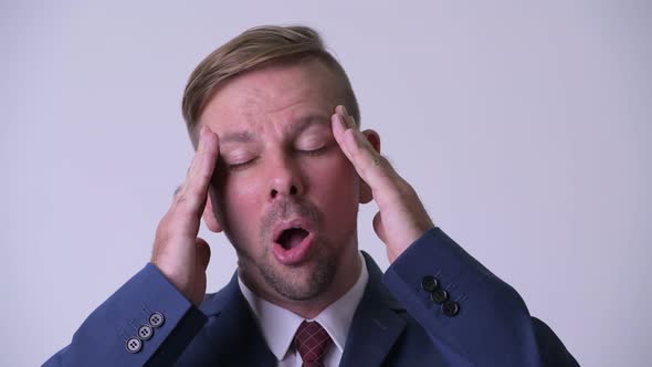 Head Shot of Stressed Blonde Businessman Having Headache