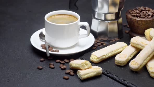 Italian Savoiardi Ladyfingers Biscuits and Cup of Coffee on Concrete Background