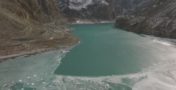 Cinematic aerial shot of Ice on the surface of Attabad Lake , Hunza , Northern area of Pakistan duri