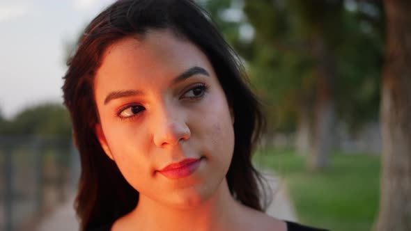 Close up on the beautiful face of a young hispanic woman looking strong, happy, and confident in cal