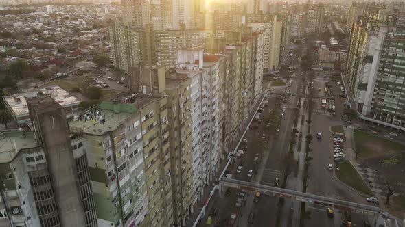 Aerial flight over old skyscraper apartments in poor district of Buenos Aires during sunset - Barrio