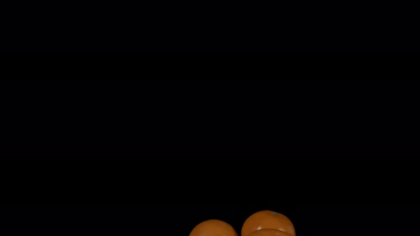 Flying Tangerines on a Black Background