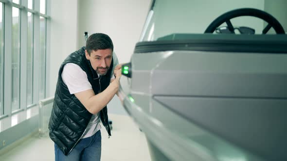 A Man Is Touching a New Speedboat in the Showroom