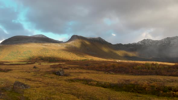 drone flying in norway with clouds and mountains.