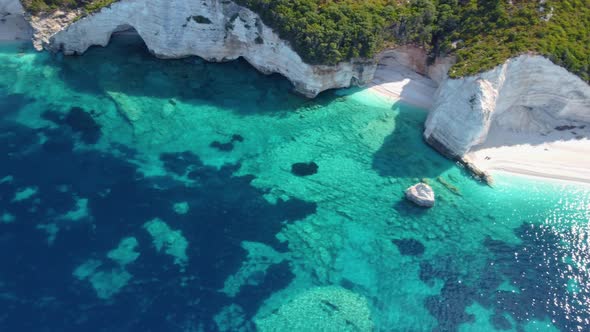 White pebble beach with turquoise blue lagoon on Ionian Island, Greece