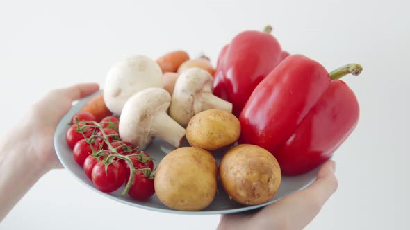 Cherry Tomatoes Carrots Potatoes Peppers Mushrooms in a Woman's Hands