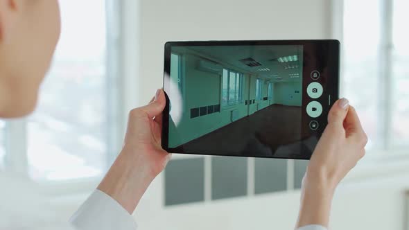 Female Architect Scans the Office Space with the Help of Additional Reality Using the Digital Tablet