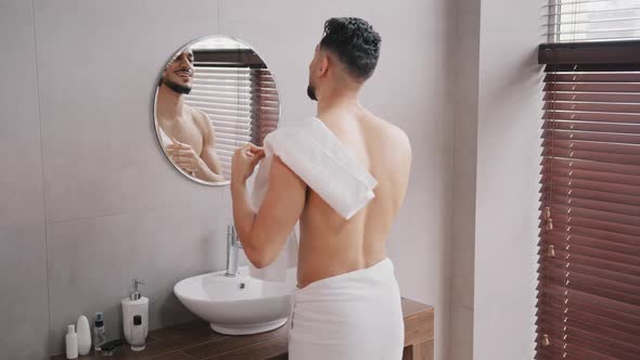 Naked Arabian Arab Indian Bearded Man Washing Face Looking in Mirror Wiping Wet Face with White