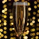 Pouring champagne into a glass against a background of fireworks and golden shining lights - VideoHive Item for Sale
