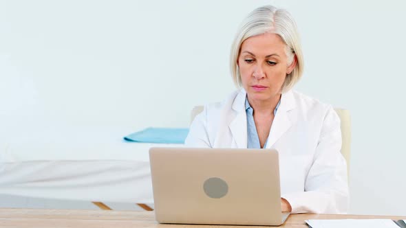 Female doctor using laptop