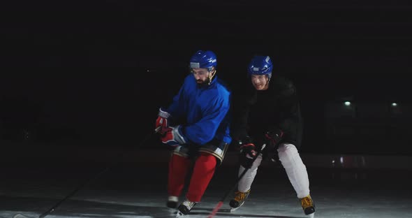 Two Man Playing Hockey on Ice Rink. Hockey Two Hockey Players Fighting for Puck. STEADICAM SHOT