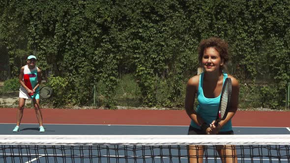 Two Girls Playing Tennis in the Pair