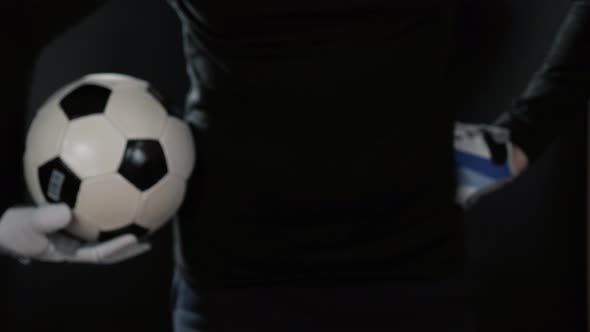 Close Up Goalkeeper Holding Soccer Ball in the Stadium Studio Football Player Hands Professional