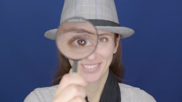 Funny Girl Looking Throw Magnifier To the Camera 