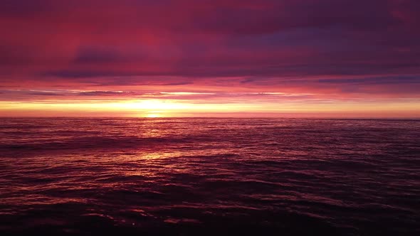 Beautiful aerial vibrant high contrast pink purple sunset over Baltic sea, Karosta war port concrete