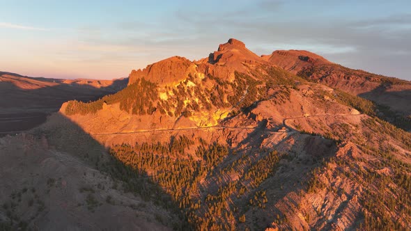 Aerial Panoramic Dramatic View of a Wilderness Mountain Peak and a Road Forest Rocky Volcanic