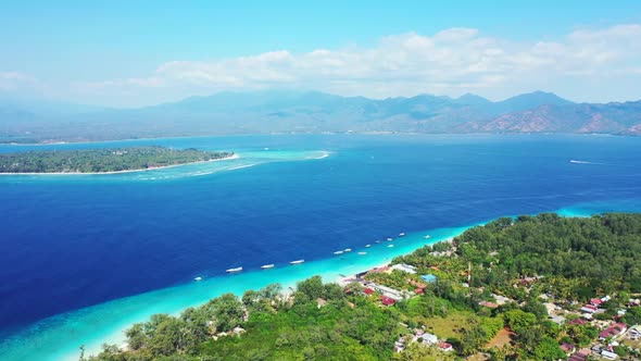 Aerial above scenery of relaxing tourist beach trip by blue sea and white sandy background of advent