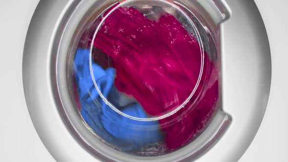 Washing Machine While Washing Colored Laundry Closeup