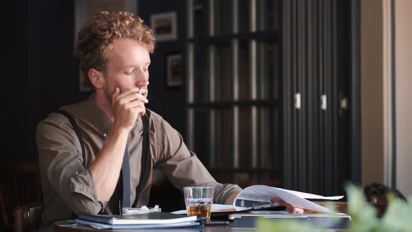 Tired Stylish Businessman Smoking and Working in a Cafe