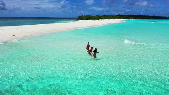 Tourists tan on relaxing coast beach wildlife by blue sea with white sand background of the Maldives